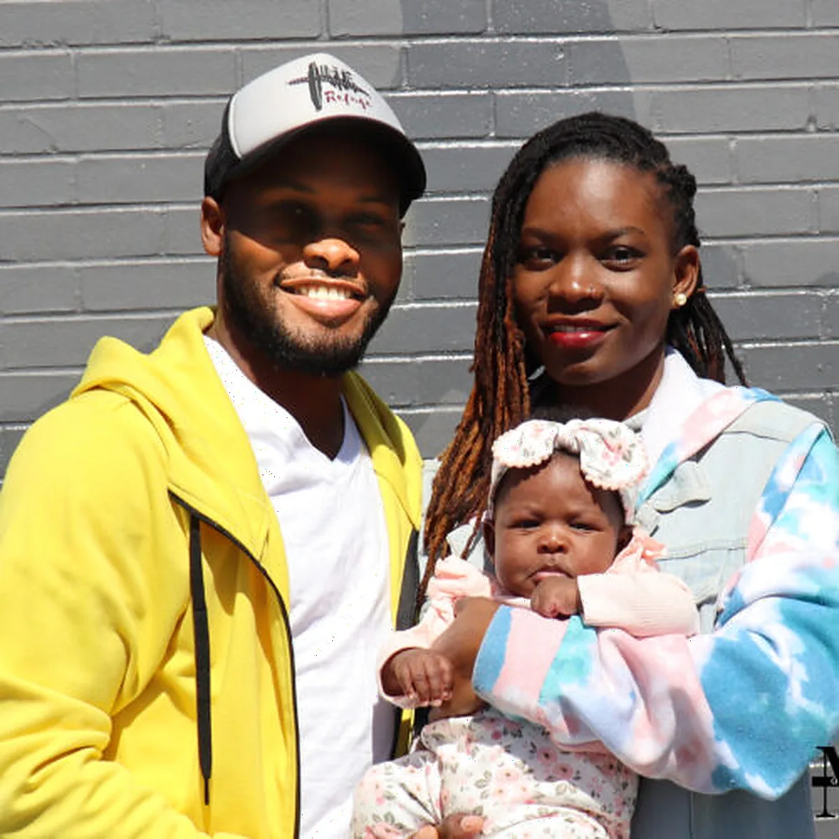A family standing together outside The Refuge.