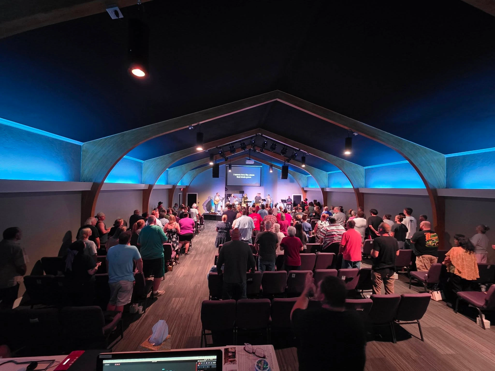 The sanctuary filled with people worshiping together at The Refuge.