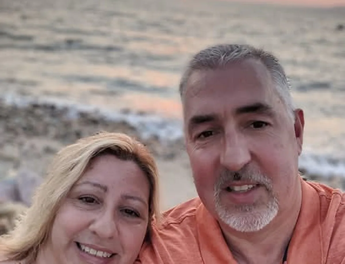 Pastor Larry and Rosana Goodwin smiling together at sunset.